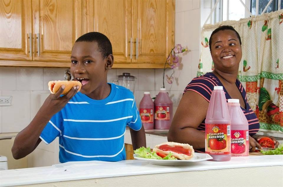 A mother and son enjoying food together in the kitchen