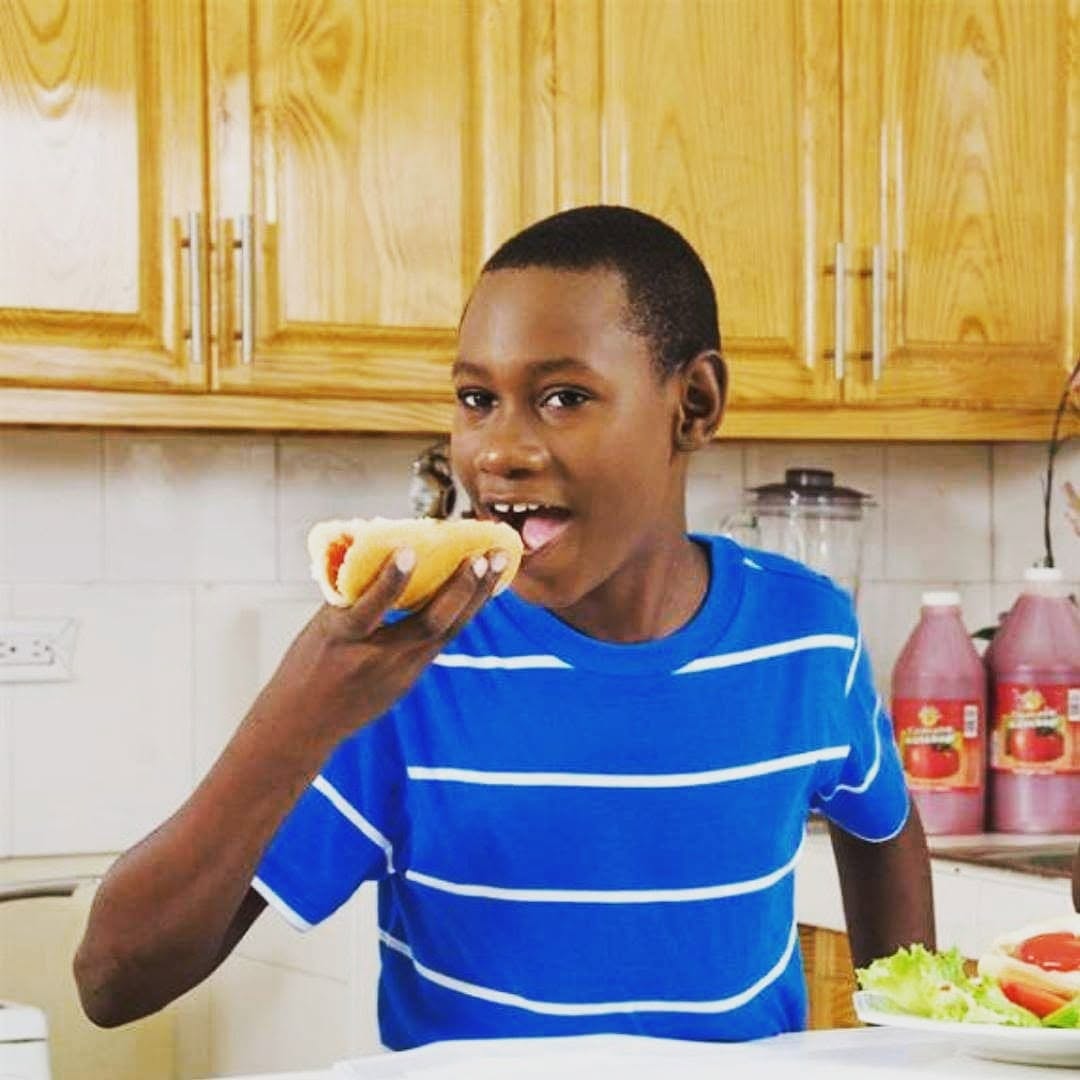 A young man enjoying a meal at the family table